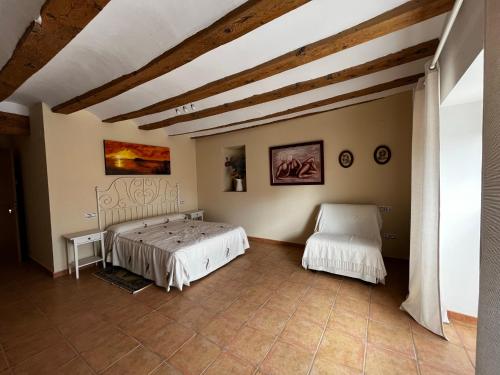 a bedroom with two beds in a room at Casa Rural Maroto in Campillo