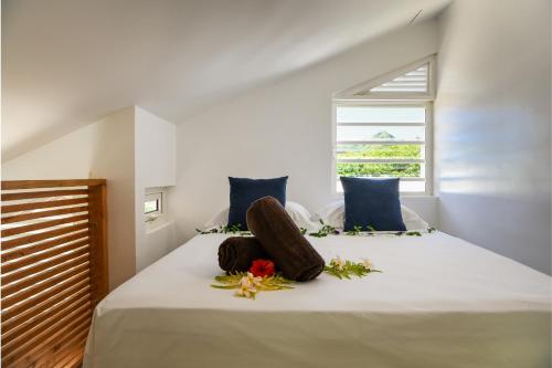 a bedroom with a white bed with flowers on it at Vaiahi Tiny Home N1377 DTO-MT in Bora Bora