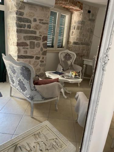 a mirror in a room with chairs and a table at New renovated Old Town Martiva Apartment in Kotor