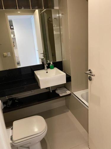 a bathroom with a white toilet and a sink at Studio en Palermo Soho in Buenos Aires
