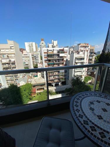 a balcony with a table and a view of a city at Studio en Palermo Soho in Buenos Aires