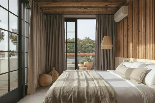 a bedroom with a large bed and large windows at Drift Santa Barbara in Santa Barbara