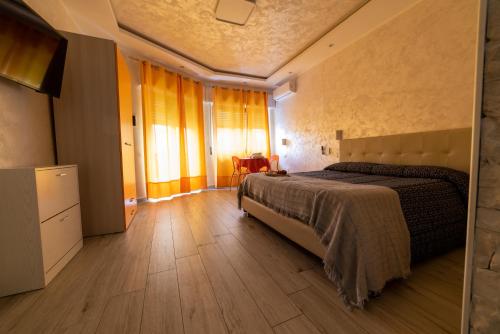 a bedroom with a bed and a wooden floor at B&B La Colonna in Crotone