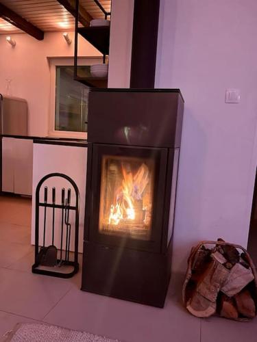 a fireplace in a room with a fire in it at Felix House Siófok in Siófok
