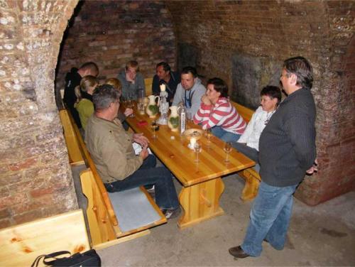 a group of people sitting around a wooden table at Privat Bohemia in Šatov