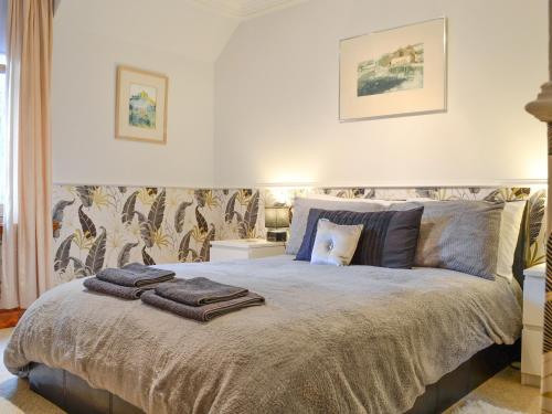 a bedroom with a bed with towels on it at Dee Valley View in Aboyne