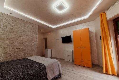 a bedroom with a bed and a yellow cabinet at B&B La Colonna in Crotone