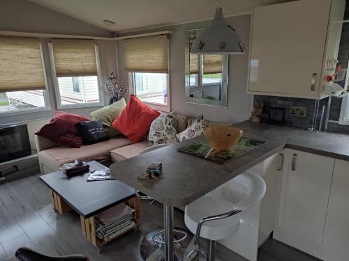 a kitchen and living room with a couch and a table at "Dew Drop Inn" in Port Seton