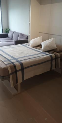 a bed with two pillows and a couch in a room at ‌skyland in Istanbul