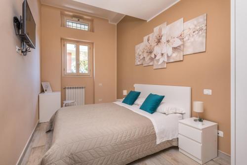 a bedroom with a large bed with blue pillows at Good Time Apartment in Ciampino