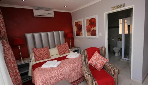 a hotel room with a bed and a chair at Avalon Guest Manor in Newcastle