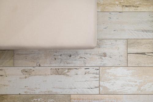 a room with a wooden floor and a white ceiling at Good Time Apartment in Ciampino