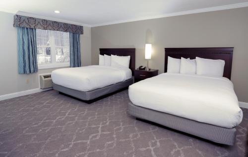Säng eller sängar i ett rum på Golden Apple Inn