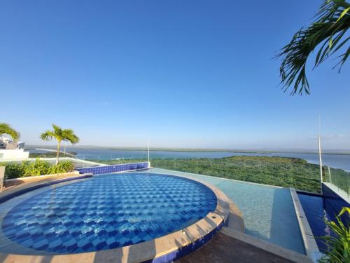 a swimming pool with a view of the ocean at 5* 1H Morros Mar y Ciénaga. Wifi y Piscina in Cartagena de Indias