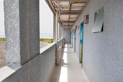 an empty hallway of a building with windows and a hallwayngth at Pousada Guaricana in Pontal do Paraná