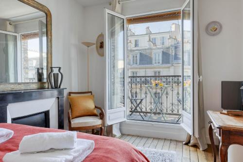 a bedroom with a bed and a window with a balcony at Ideal 1 Bd Flat with Balcony - Paris 05 in Paris