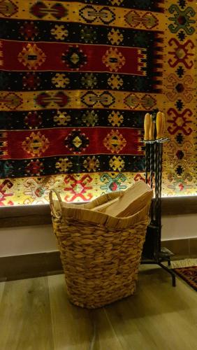 a basket sitting in front of a wall with a rug at B&B Plitvice Holiday Lodge in Plitvička Jezera