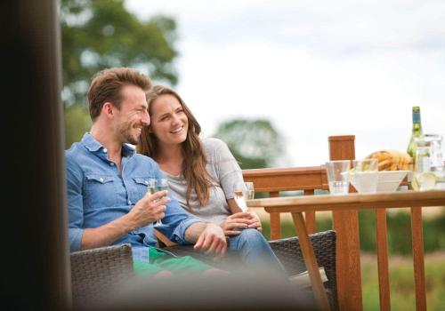 a man and a woman sitting at a table at Wigmore Lakes Lodges in Cardeston