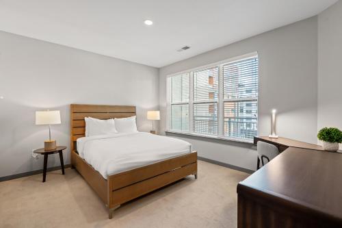 1 dormitorio con cama, escritorio y ventana en WhyHotel by Placemakr, Columbia en Columbia