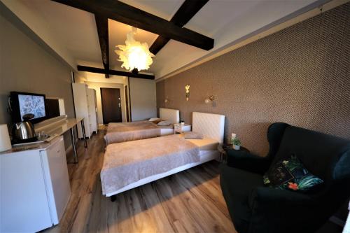 a living room with two beds and a couch at Zajazd Stodoła sauna w cenie in Stronie Śląskie
