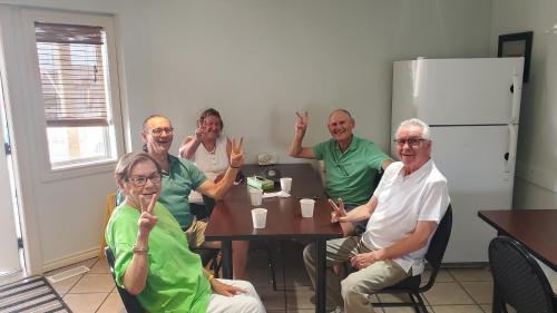 een groep mensen die rond een tafel zitten bij Shoreside Inn & Suites in Wabamun