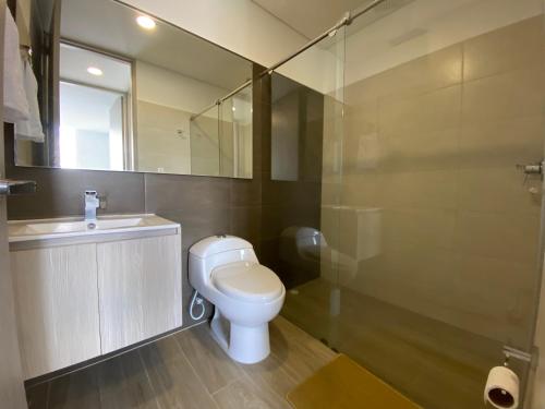 uma casa de banho com um WC, um lavatório e um espelho. em Elegancia y calidad el mejor sitio de la ciudad em Ibagué