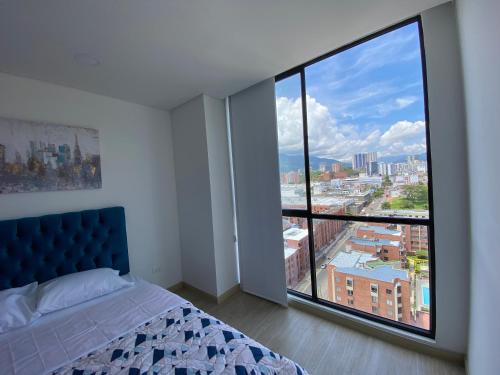 1 dormitorio con cama y ventana grande en Elegancia y calidad el mejor sitio de la ciudad, en Ibagué