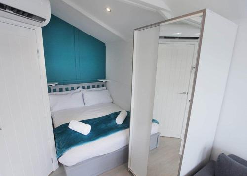 a small bedroom with a bed and a mirror at Mercury Yacht Harbour And Holiday Park in Lower Swanwick