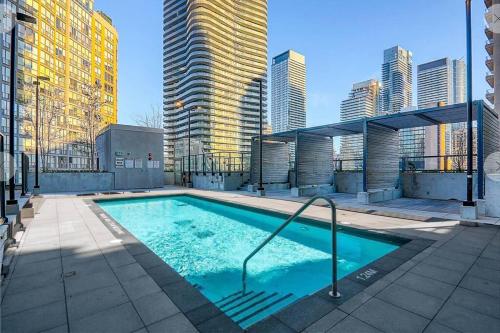 a swimming pool in a city with tall buildings at Luxury Condo on Bay Street in Toronto