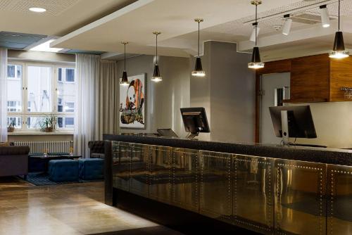 a bar in a waiting room with lights at Radisson Blu Aleksanteri Hotel, Helsinki in Helsinki