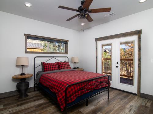 a bedroom with a bed and a ceiling fan at Cliff's Edge. New Build, Breathtaking Views, Luxury Stay Near Zion in Orderville