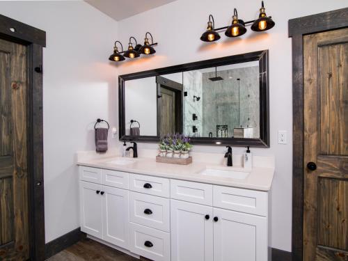 a bathroom with a white sink and a mirror at Cliff's Edge. New Build, Breathtaking Views, Luxury Stay Near Zion in Orderville