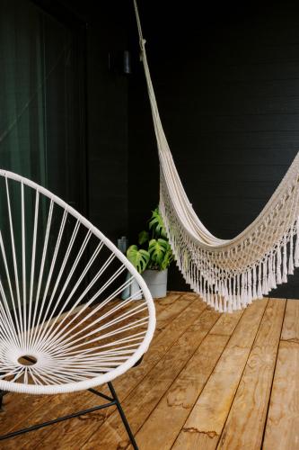 two white hammocks sitting on a wooden floor at Twelve Senses Retreat, a Member of Design Hotels in Encinitas