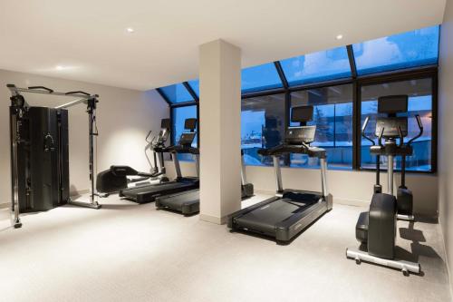 a gym with treadmills and ellipticals in a room with windows at AC Hotel Frisco Colorado in Frisco