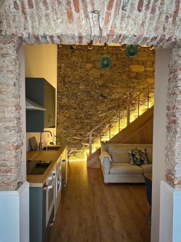 a kitchen and living room with a couch and a table at 4Cantos Alentejo in Mértola