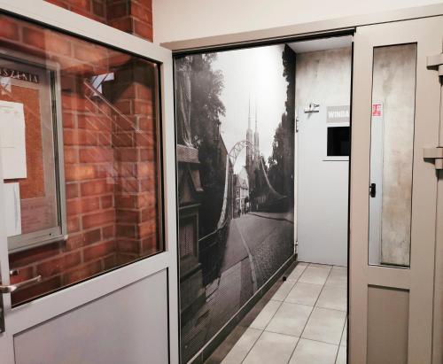 a door with a picture on the side of a building at Apartament dla 1-4 osób w Golden House in Wrocław