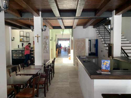 a restaurant with wooden ceilings and tables and chairs at Hotel Villa Salvador in Salvador