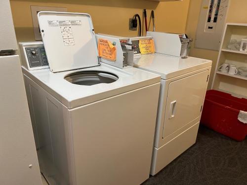 a white washer and dryer in a room at Char's Landing Hostel in Port Alberni