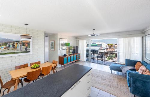 a living room with a blue couch and a table at The Springs - oceanstays in Yamba