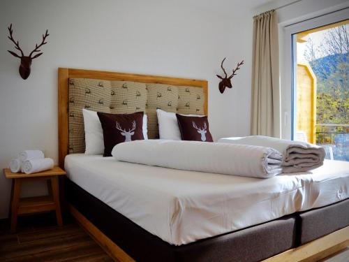 een slaapkamer met een bed met witte lakens en een raam bij Bergblick in Werfenweng