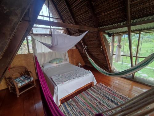 um quarto com uma cama e uma rede de descanso num quarto em Casa de Campo "Villa Maria" em Sauce