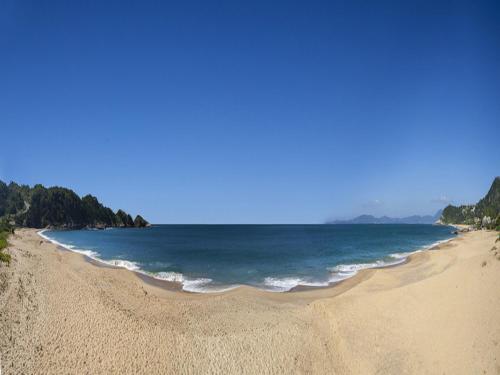 a view of a beach with the ocean at Pousada Ponta do Lobo in Balneário Camboriú