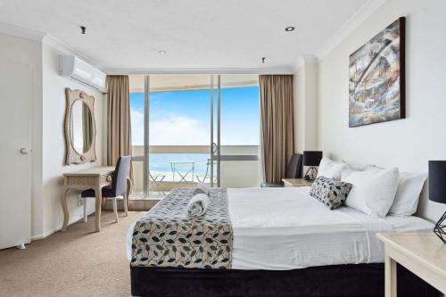 a bedroom with a bed with a view of the ocean at Focus Apartments With Ocean Views in Gold Coast
