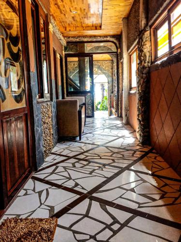 a hallway with a tiled floor in a building at Sầm Sơn Boutique Hotel Phan Thiết in Phan Thiet