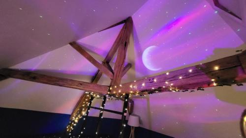 a ceiling with a starry sky and lights at Gîte au cœur des vignes avec piscine et spa in Saudoy