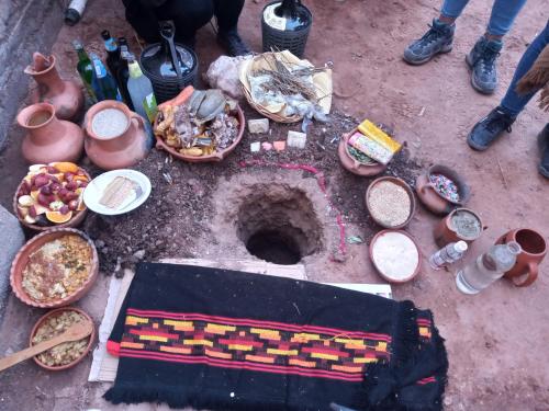 a group of bowls of food on the ground at Hostal familiar Hornocal in Humahuaca
