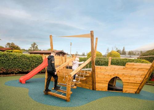 a man and a woman on a playground at Ben Nevis Holiday Park in Banavie