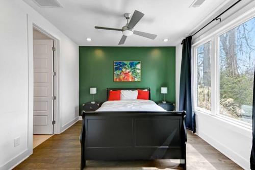 a bedroom with a black bed and a green wall at Nashville Vibe/3 Miles 2BroadWay/11 bds in Nashville