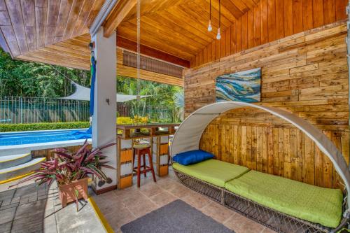 a room with a bed in the middle of a house at Villas Verdes in Sámara