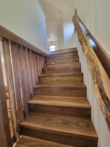 a staircase with wooden steps and a wooden rail at Mallory Estate in Chariton